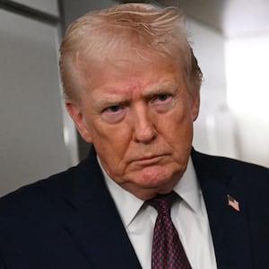 US President Donald Trump speaks to the press aboard Air Force One on January 11, 2026.