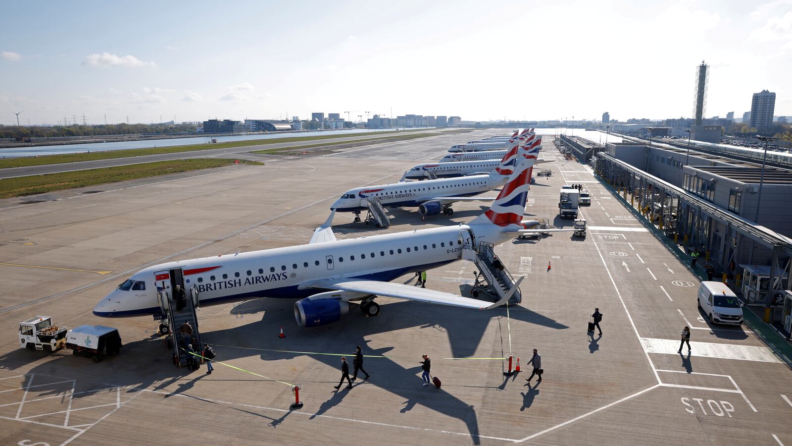Passengers board a British Airways Embraer 190 aircraft at London City Airport.