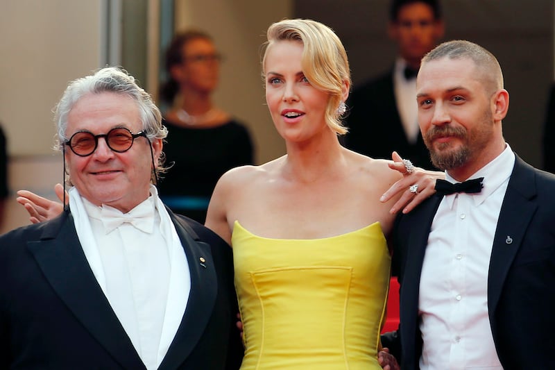 Director George Miller, cast members Charlize Theron and Tom Hardy pose on the red carpet as they arrive for the screening of the film "Mad Max: Fury Road" out of competition at the 68th Cannes Film Festival
