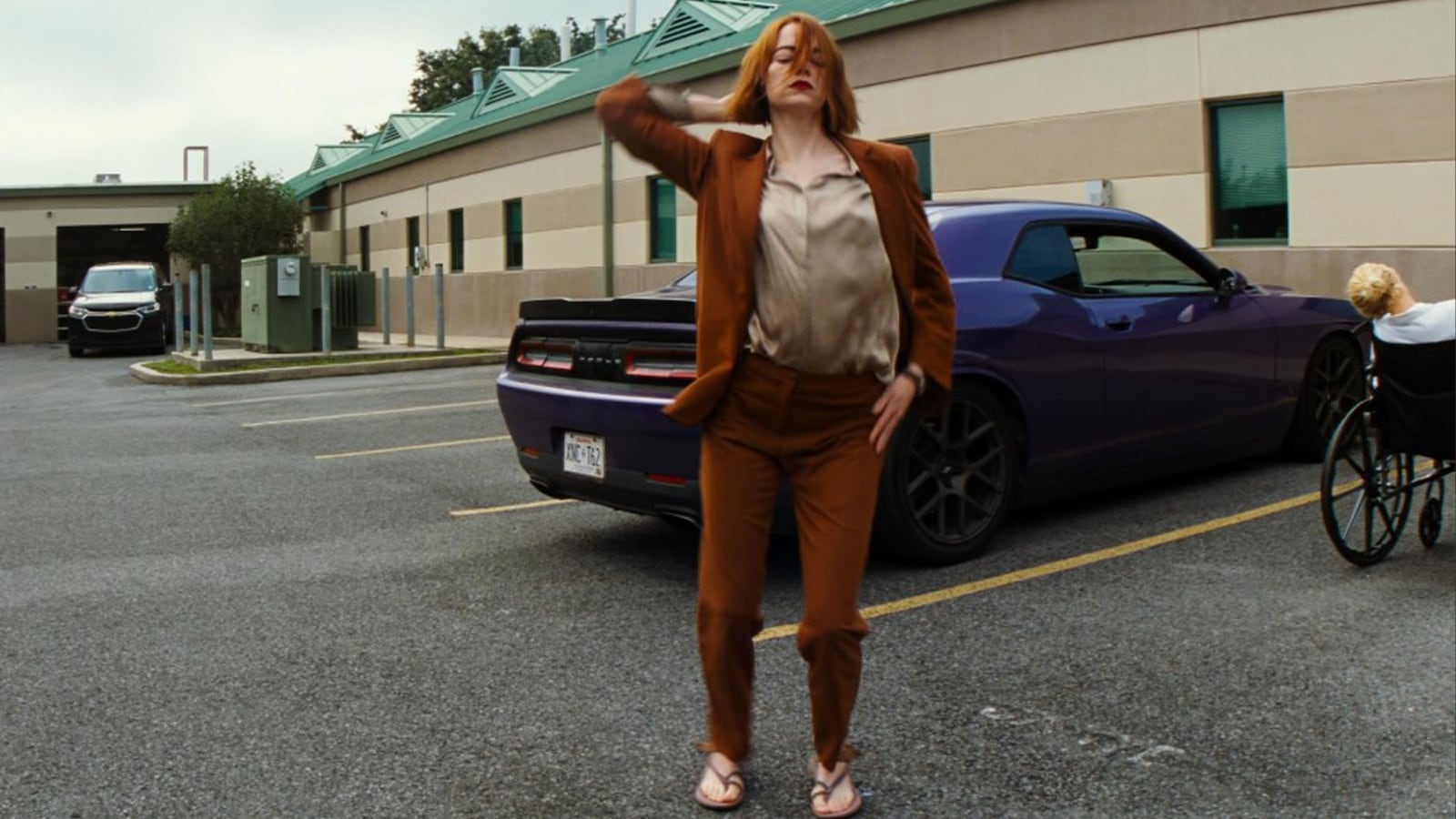 Emma Stone dances in a street in 'Kinds of Kindness'