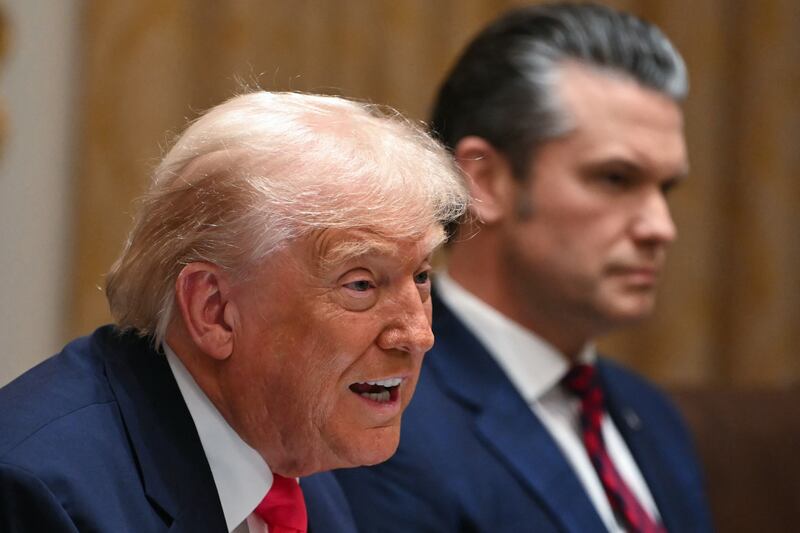 (L/R) US President Donald Trump speaks alongside Secretary of Defense Pete Hegseth during a Cabinet Meeting in the Cabinet Room of the White House in Washington, DC on December 2.