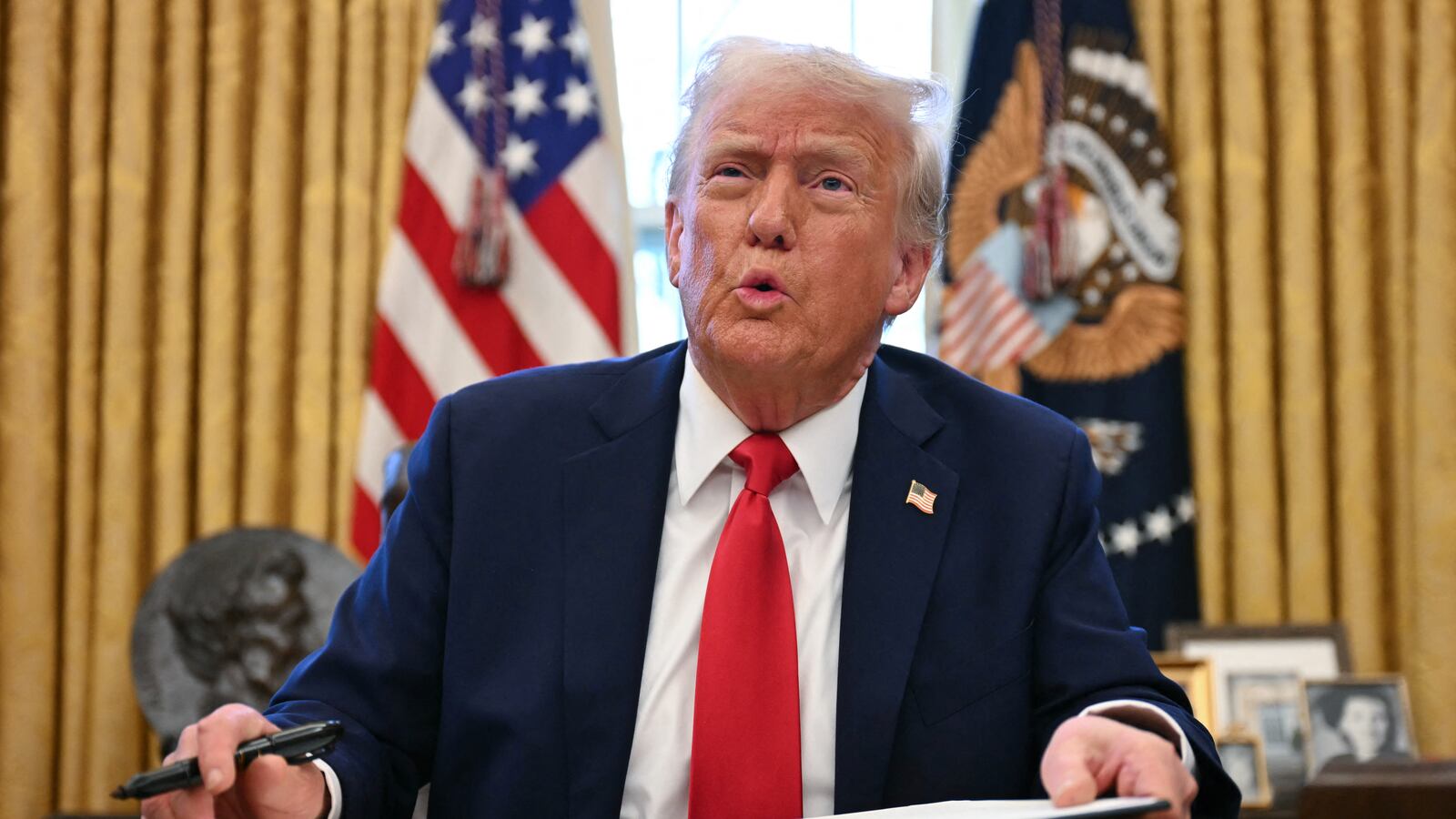 President Donald Trump signing an executive order in the White House.