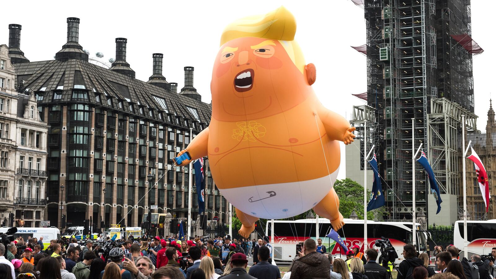 A 20-feet tall "Trump Baby" balloon depicting the President of the United Stetes as an angry orange infant with a smartphone, flies above Parliament Square on the second day of Donald Trump's three-day state visit to the United Kingdom on 04 June, 2019 in London, England.