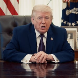 President Trump sits behind the Resolute Desk in a Truth Social video.