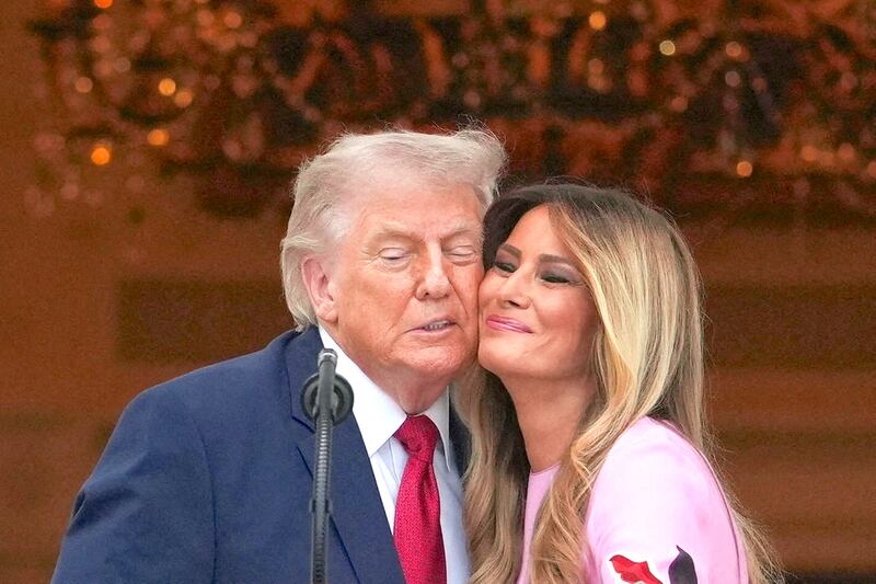 U.S. President Donald Trump and first lady Melania Trump stand close to each other during the Congressional Picnic at the White House in Washington, D.C., U.S., May 19, 2026.