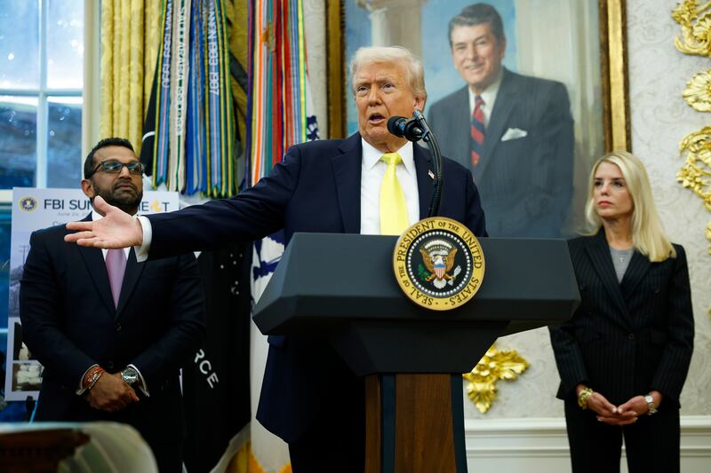 U.S. President Donald Trump (C) speaks as Federal Bureau of Investigation Director Kash Patel (L) and U.S. Attorney General Pam Bondi look on during a press conference in the Oval Office of the White House on October 15, 2025 in Washington, DC.