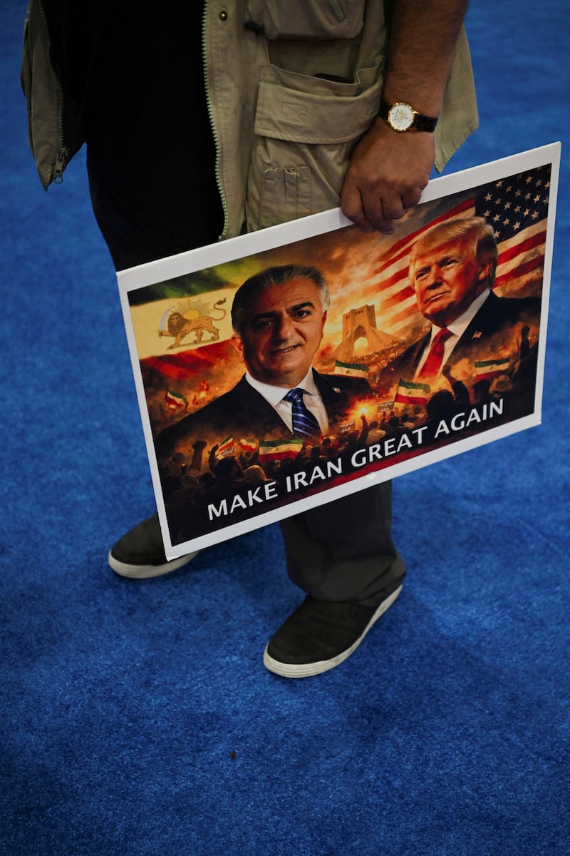 FILE PHOTO: A person holds a sign reading "Make Iran great again" during the Conservative Political Action Conference (CPAC) USA 2026 in Gaylord Texan Resort and Convention Center, in Grapevine, Texas, U.S., March 25, 2026.  REUTERS/Callaghan O'Hare/File Photo