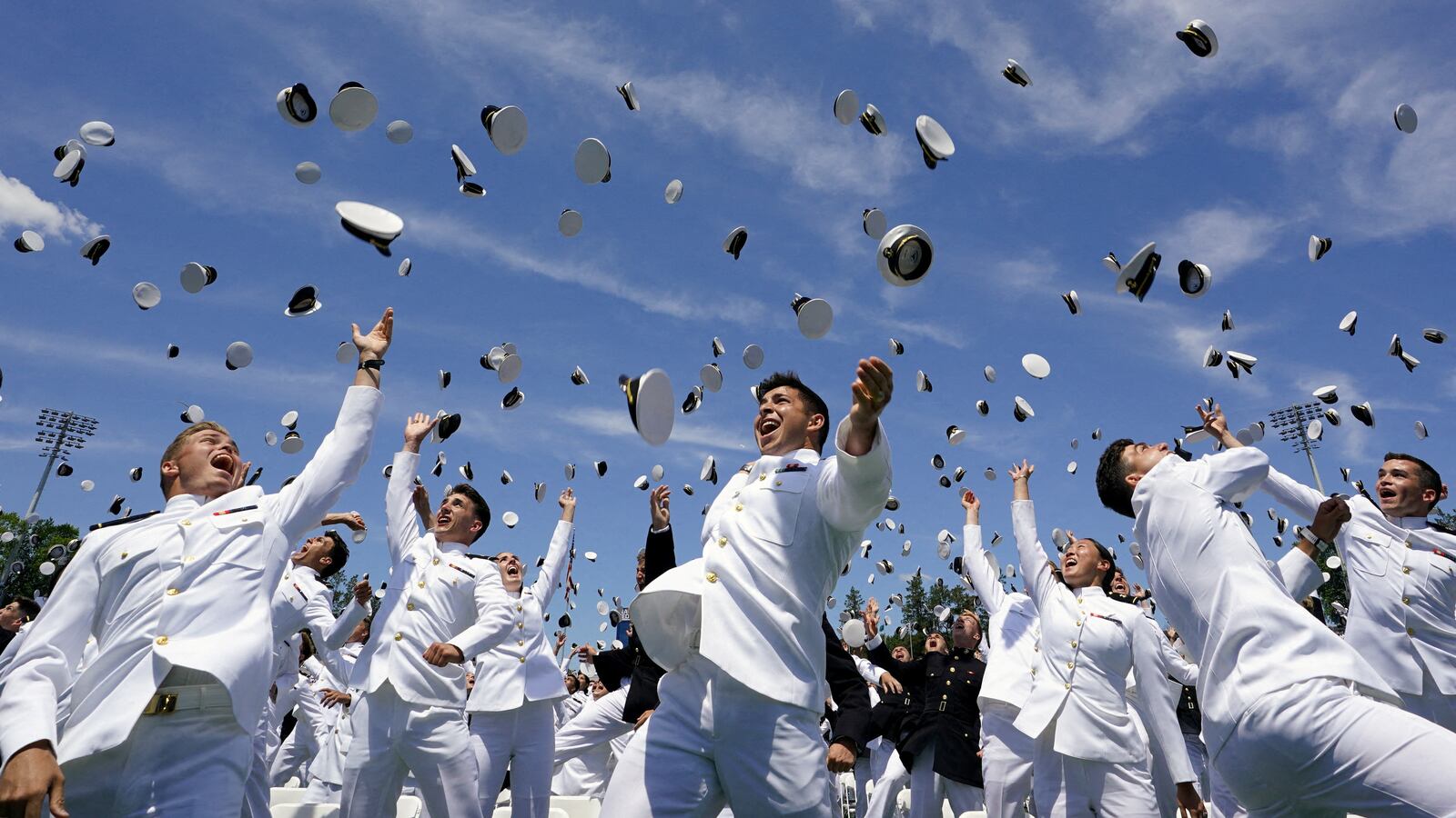 Graduates toss their caps in the air in celebration at the conclusion of the U.S. Naval Academy graduation and commissioning ceremony in Annapolis, Maryland, May 26, 2023.