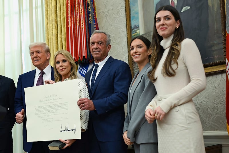 US President Donald Trump (L) poses with Robert F. Kennedy Jr. (C), his wife Cheryl Hines (2nd L) and daughters Kyra Kennedy (2nd R) and Kathleen Kennedy (R) after Kennedy was sworn in as Secretary of Health and Human Services in the Oval Office of the White House in Washington, DC, on February 13, 2025.
