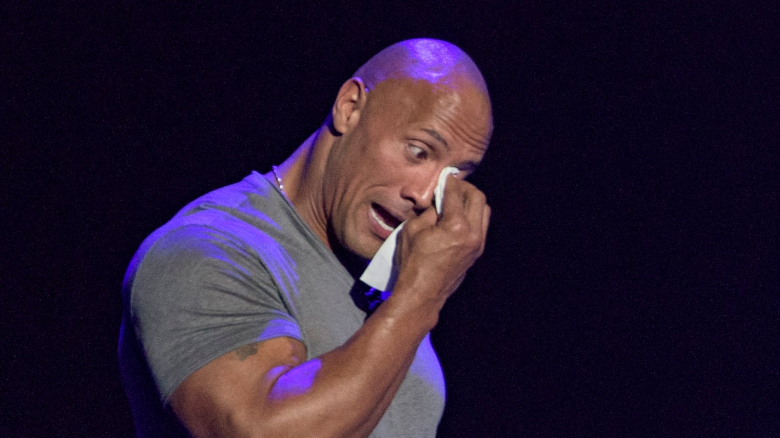 Dwayne Johnson tearing up on stage.