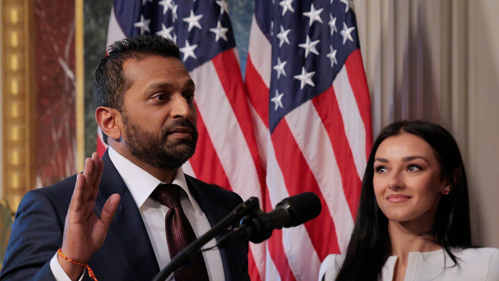 FBI Director Kash Patel speaks as his girlfriend Alexis Wilkins (C) looks on during his swearing-in ceremony on Feb. 21, 2025, in Washington, DC.