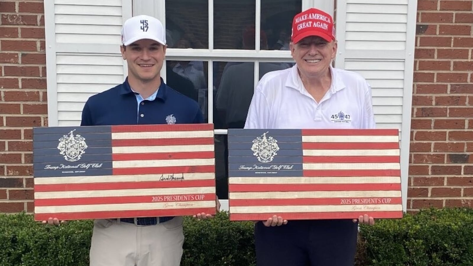 Donald Trump (right) commemorative American flags while next to his golf partner, Thomas Urciuoli.