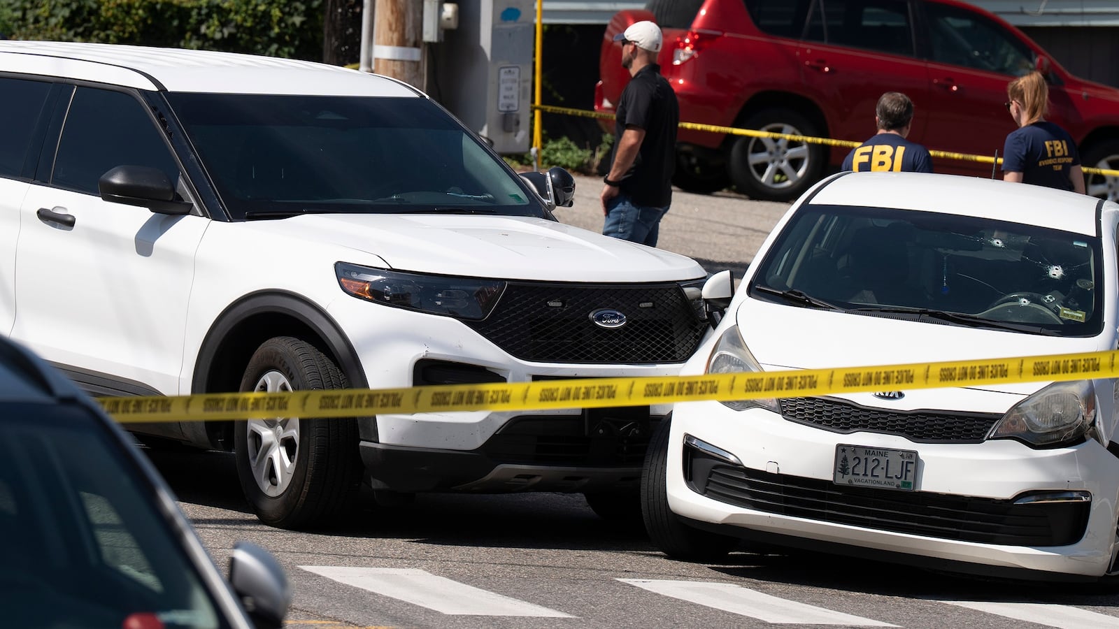 BIDDEFORD, ME - JULY 13: A Kia sedan reportedly driven by the victim of a fatal shooting can be seen with four bullet holes in the windshield at the scene on Pool Street in Biddeford on Monday, July 13, 2026. (Gregory Rec/Portland Press Herald via Getty Images)