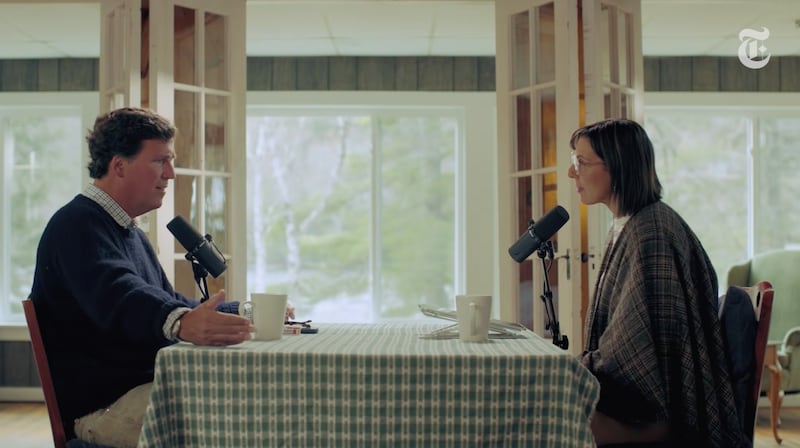 Tucker Carlson sits opposite NY Times reporter, Lulu Garcia-Navarro in a house in Maine.