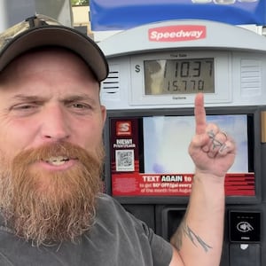 Country rapper Adam Calhoun stands in front of a diesel pump and discusses the high cost of living.