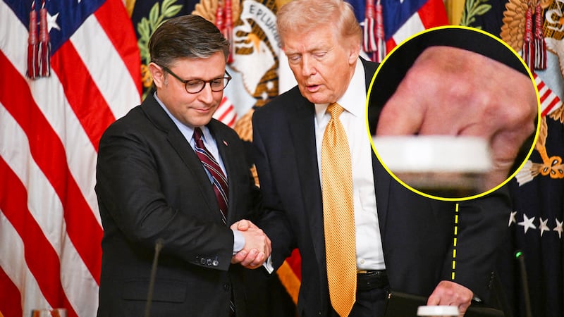 US President Donald Trump shakes hands with US Speaker of the House Mike Johnson (L), Republican from Louisiana as he arrives during a lunch with the Kennedy Center Board Members in the East Room of the White House on March 16, 2026 in Washington, DC. (Photo by Annabelle GORDON / AFP via Getty Images)