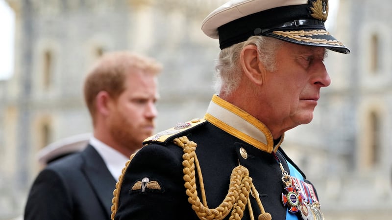 King Charles III (center) and Prince Harry follow the hearse with the coffin of Queen Elizabeth II moving towards St. George's Chapel at Windsor Castle, during the queen's funeral on September 19, 2022.