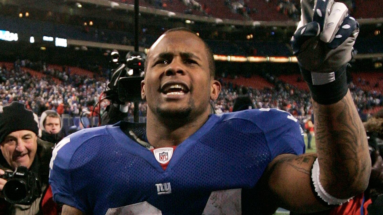 Derrick Ward celebrates on the field after a playoff win for the New York Giants in 2008.