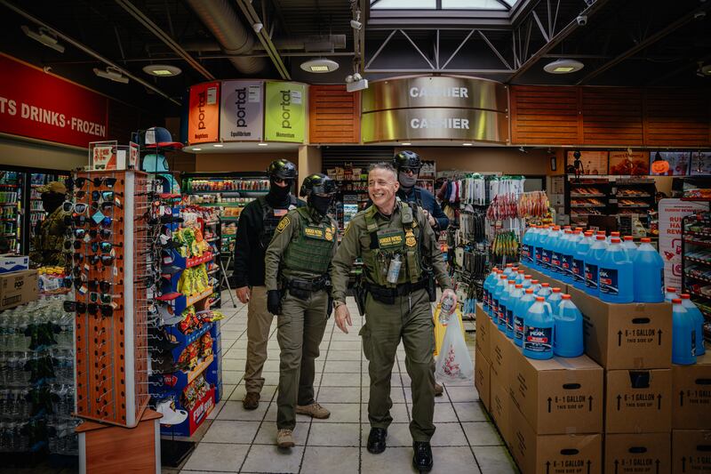 Patrol Agent of the El Centro Sector for U.S. Customs and Border Protection Gregory Bovino talks with other federal agents during a gas station stop to buy snacks and use the restroom.