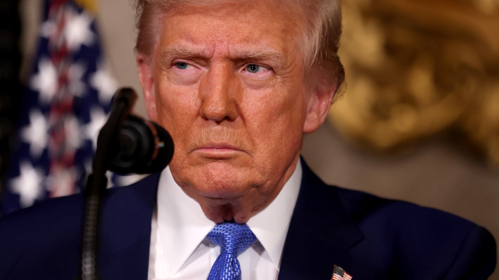 A close-up shot of President Donald Trump standing in front of a microphone at his Mar-a-Lago resort in Palm Beach, Florida.