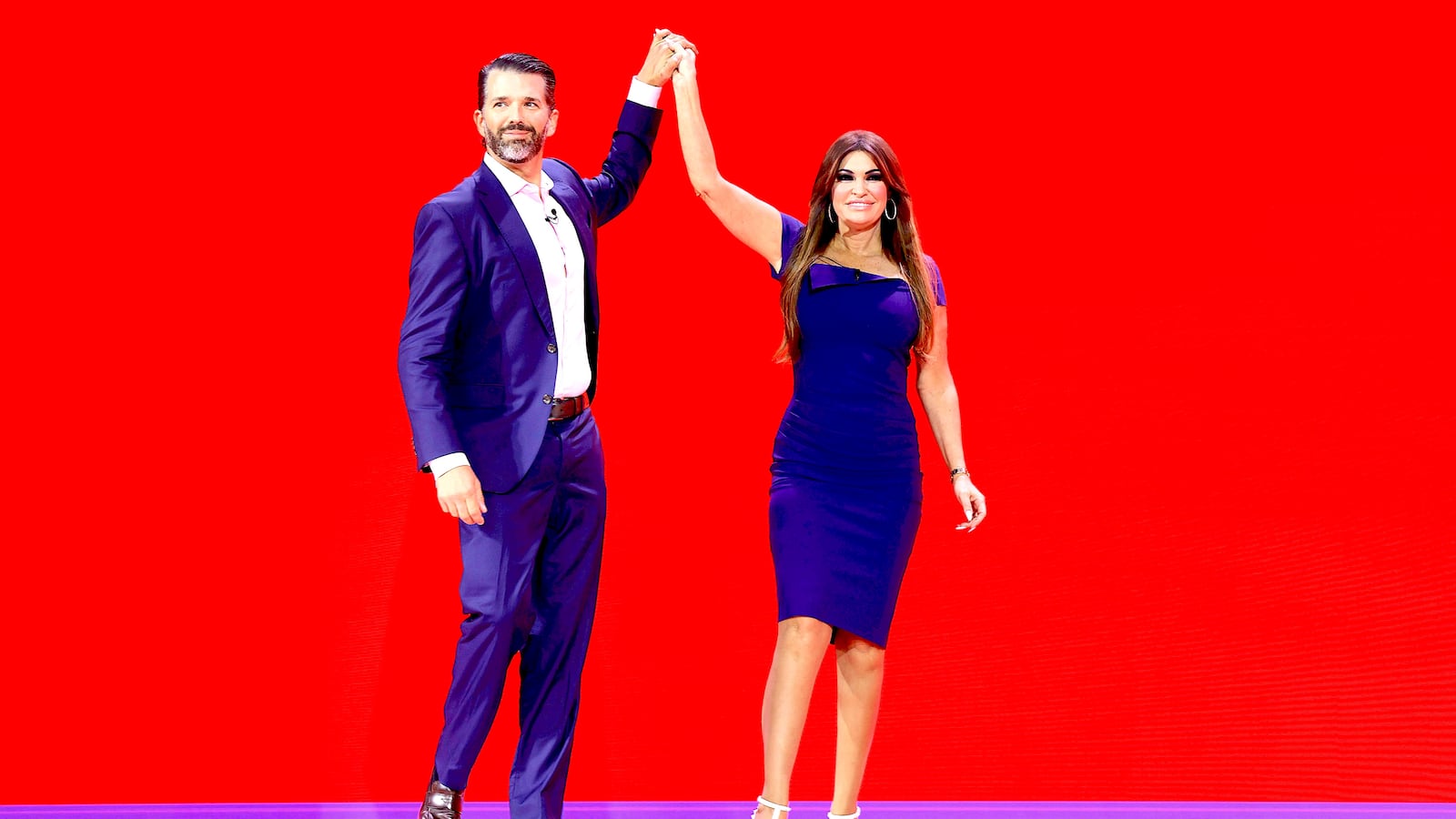 Donald Trump Jr. high fives Kimberly Guilfoyle before speaking at the annual Conservative Political Action Conference (CPAC)