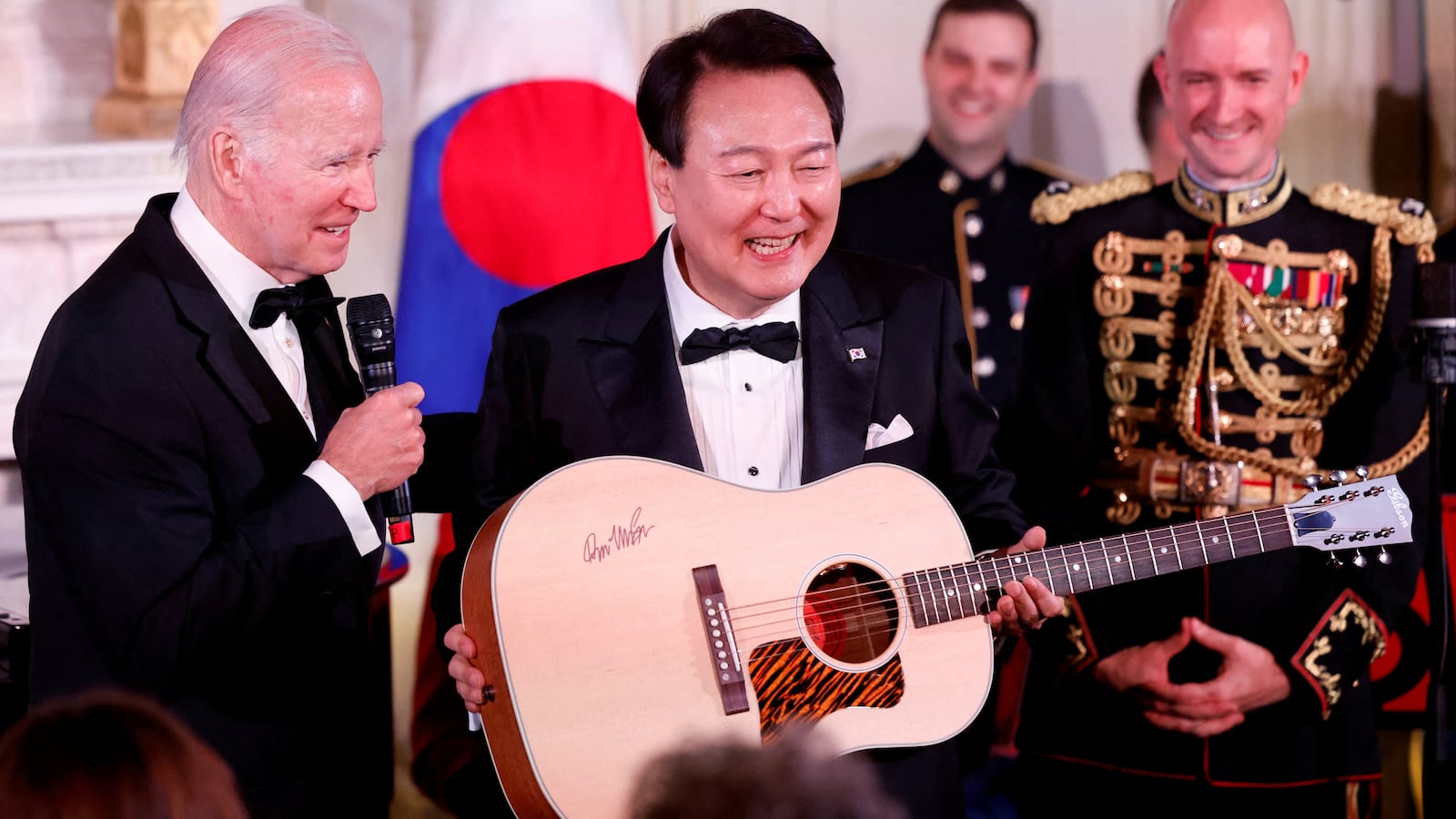 U.S. President Joe Biden presents a guitar signed by artist Don McLean during South Korea's President Yoon Suk Yeol's visit at the White House in Washington, U.S. April 26, 2023.